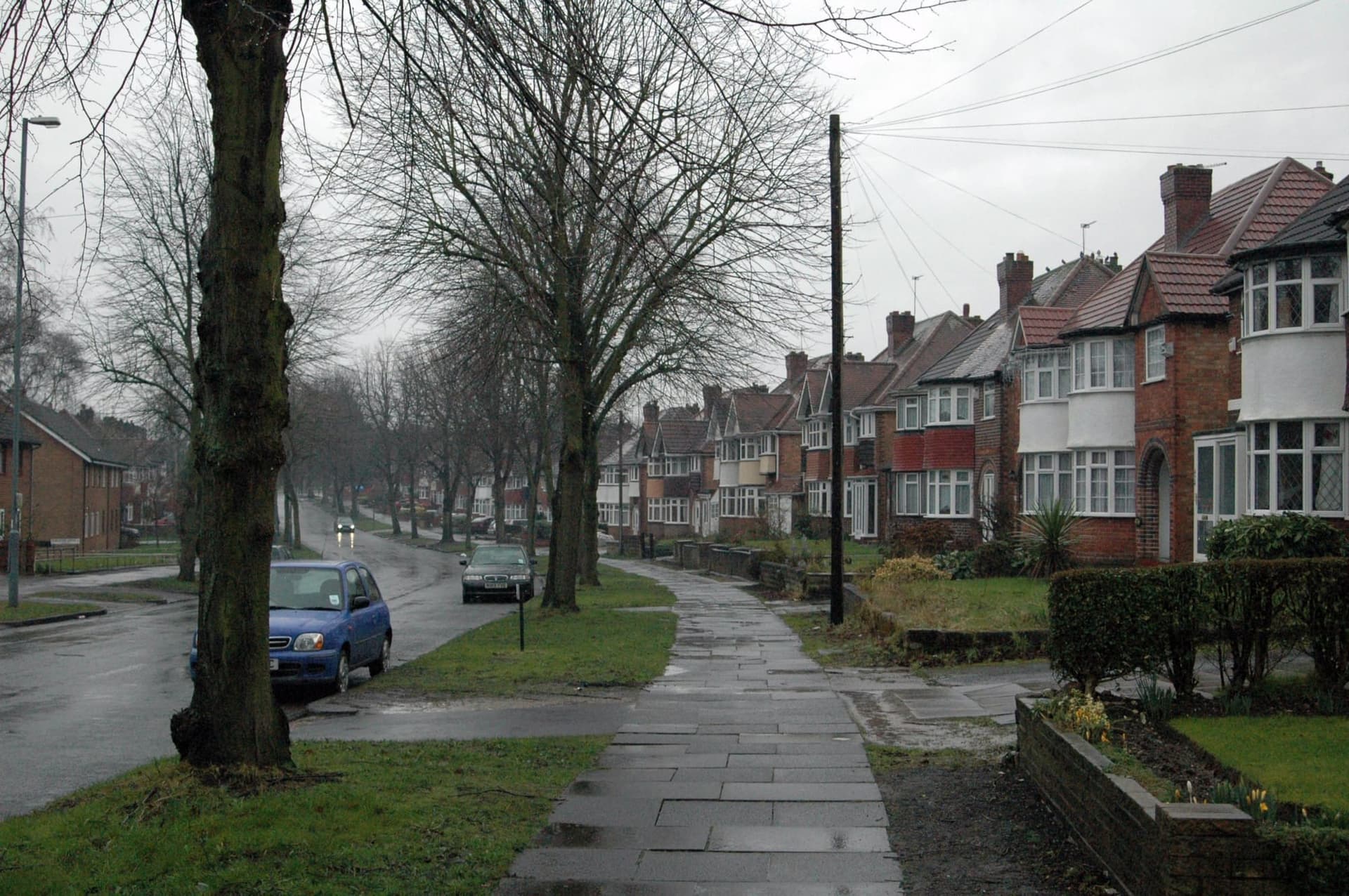 A street of 1930s semi-detached houses with hipped roofs and bay windows in Hall Green