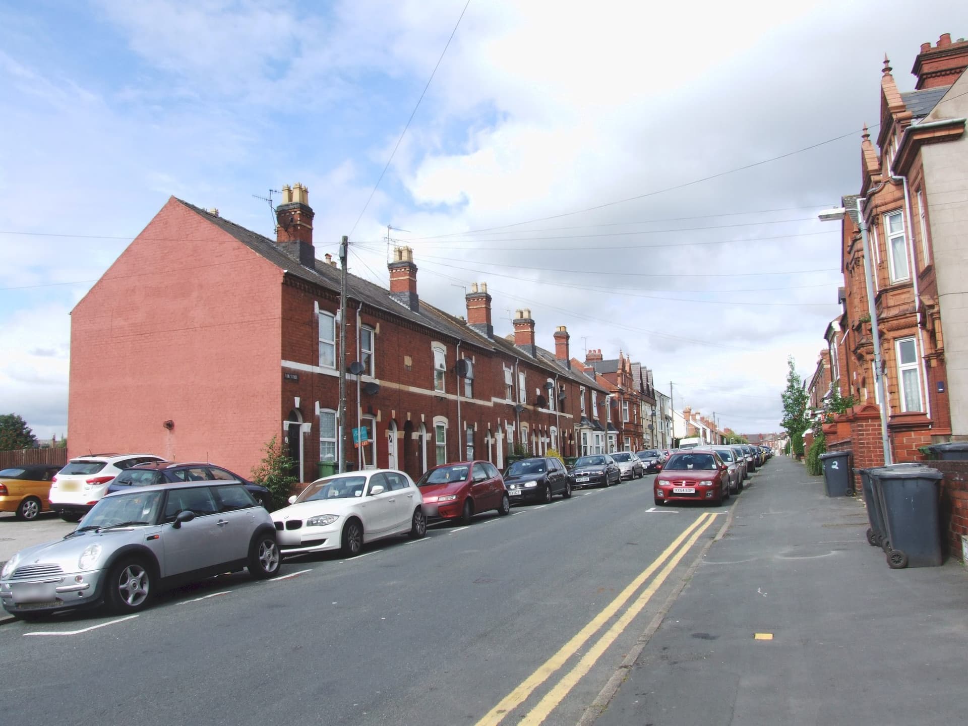 Red-brick terraced houses with slate roofs and tall chimney stacks on Lea Street, Kidderminster