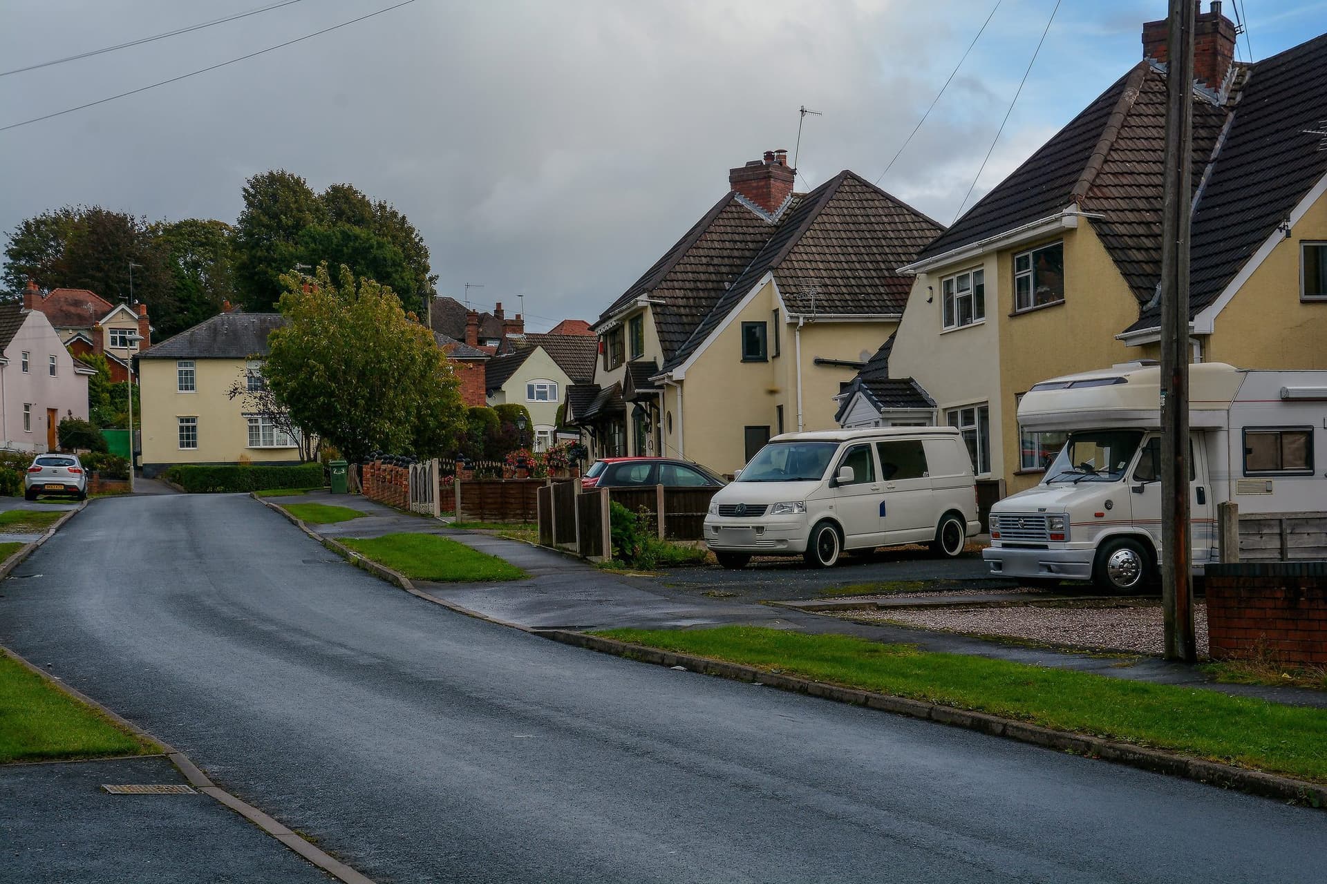 Cream-rendered semi-detached houses with steep tiled roofs and front gables on Stream Park, Kingswinford