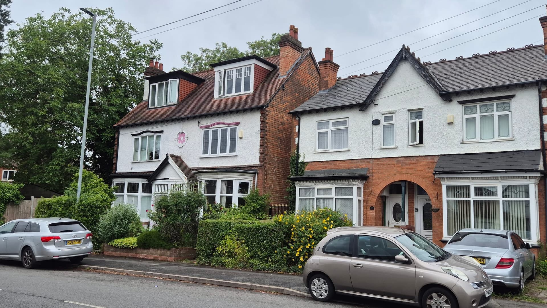 Tall semi-detached houses with gables and attic windows on Springfield Road, Moseley