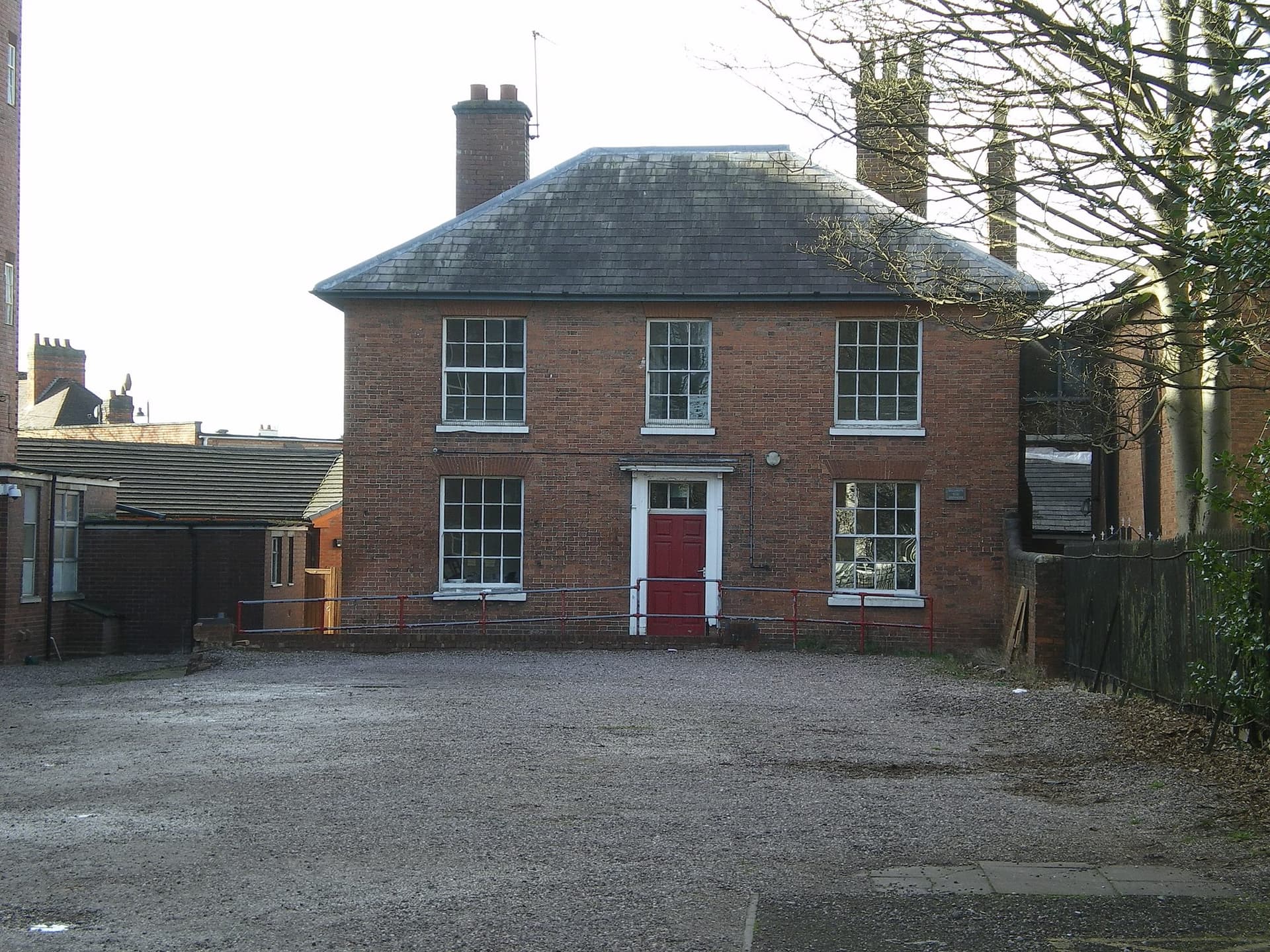 Former chapel manse in Cannock: a two-storey red brick house with a hipped slate roof, sash windows and a red front door