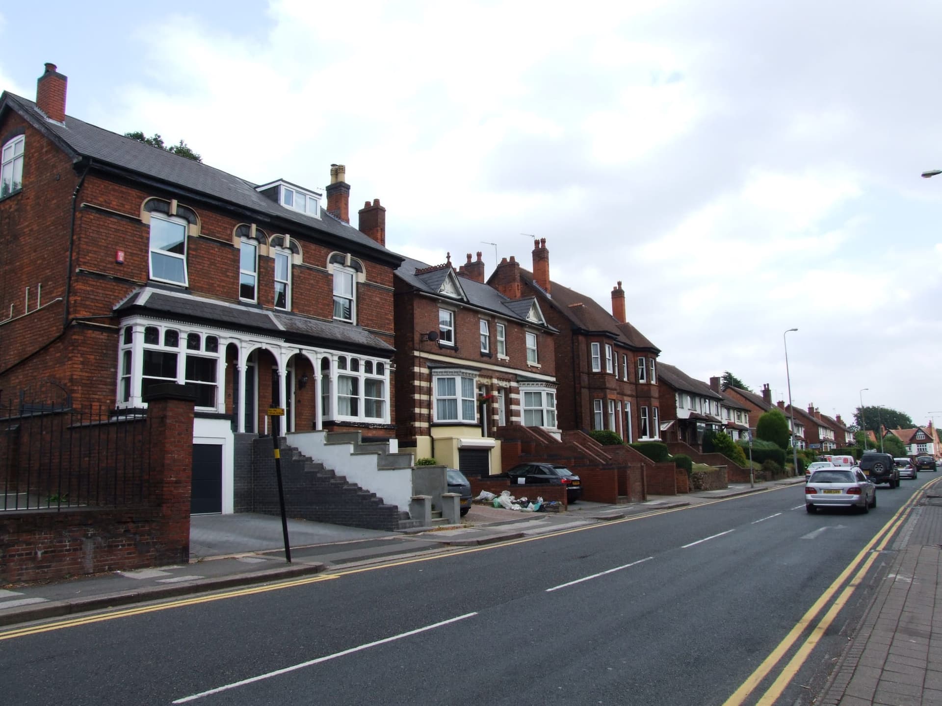 Large Victorian brick houses with gables and attic windows on Victoria Road, Sutton Coldfield
